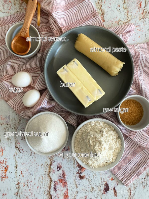 Almond extract, almond paste, butter, eggs, sugar, flour, and raw sugar