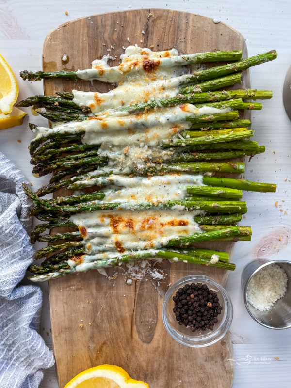 Top view of garlic cheese asparagus with melted cheese