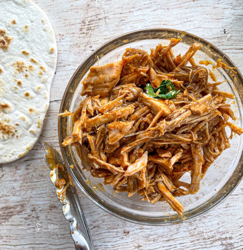 one bowl of cilantro lime pork in bowl with tortila