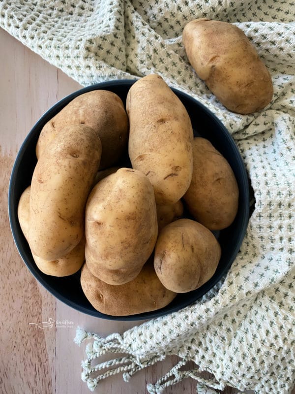 Top view of russet potatoes in blue bowl