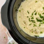 Top view of mashed potatoes in the Crockpot with chives