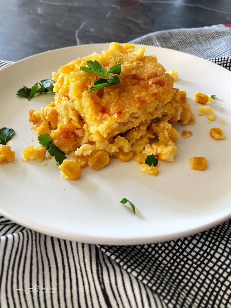 Corn pie on white plate with parsley