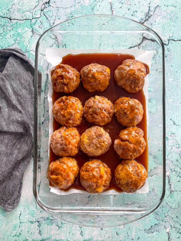 Top view of baked ham balls with sauce