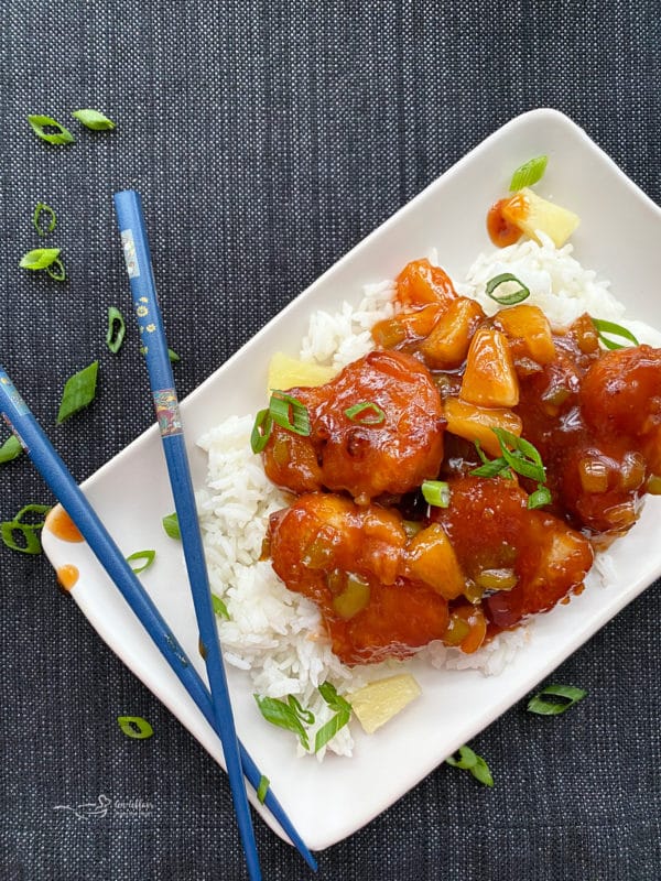 top view of sweet & sour chicken with bed of rice 