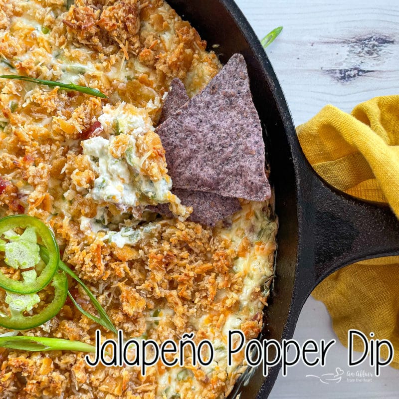 top view of jalapeño popper dip with chip in skillet