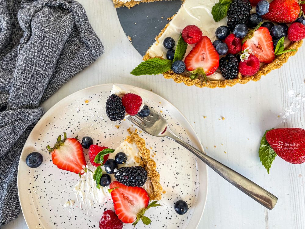 one plate with a slice of no bake fruit tart with fresh berries