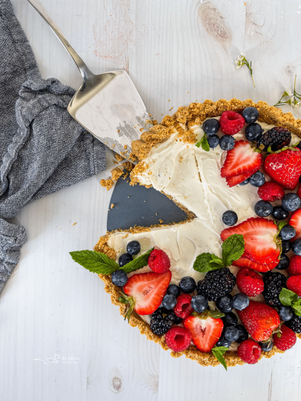 top view of one no bake fruit tart with fresh berries and mint