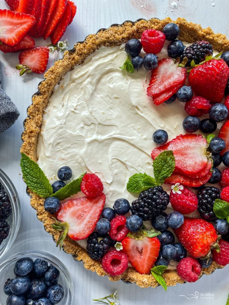 Top view of no bake fruit tart with fresh blueberries, strawberries, blackberries, and raspberries