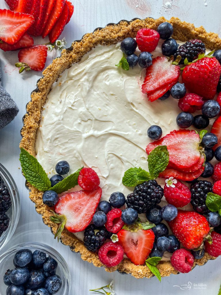 Top view of no bake fruit tart with fresh blueberries, strawberries, blackberries, and raspberries