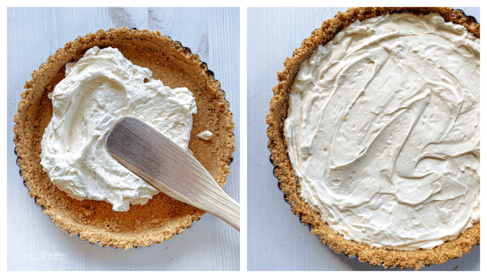 cream cheese mixture being spread on graham cracker crumbs