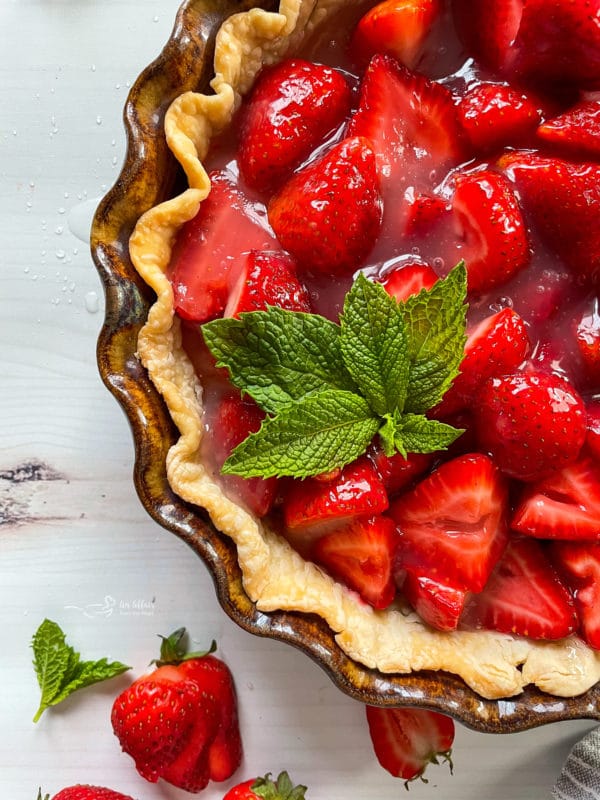 top view of fresh strawberry pie with mint on top