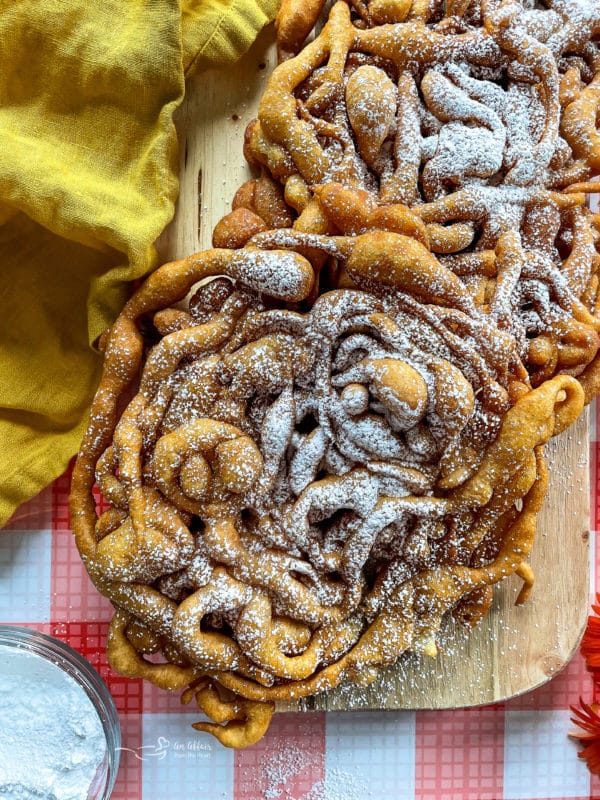 funnel cakes on wooden board