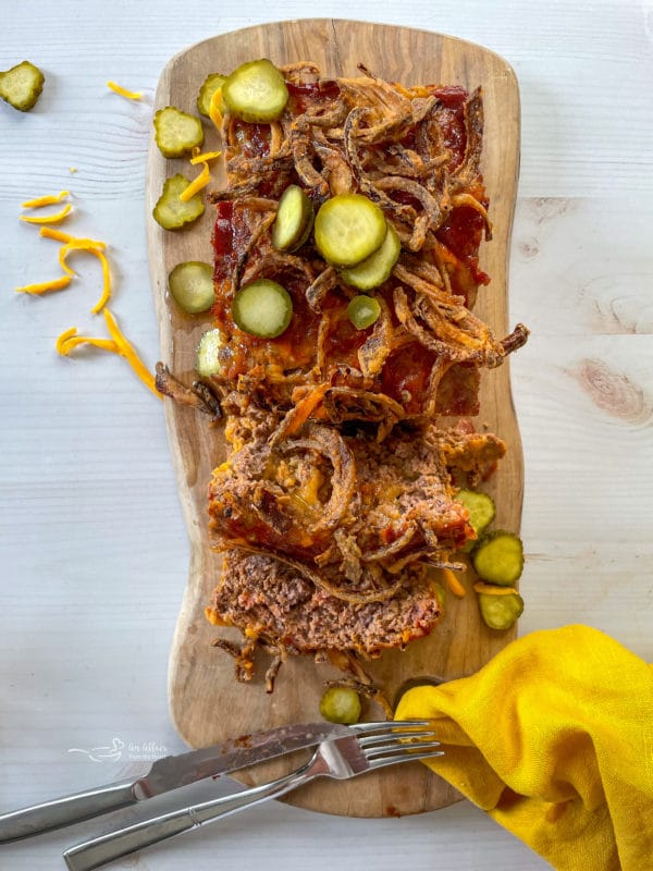 bacon cheeseburger meatloaf topped with fried onions and pickles