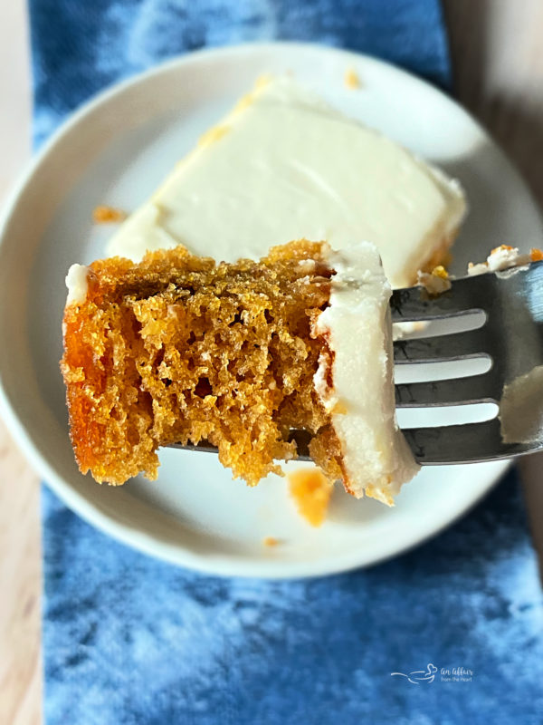 bite of carrot cake bar with cream cheese frosting on fork