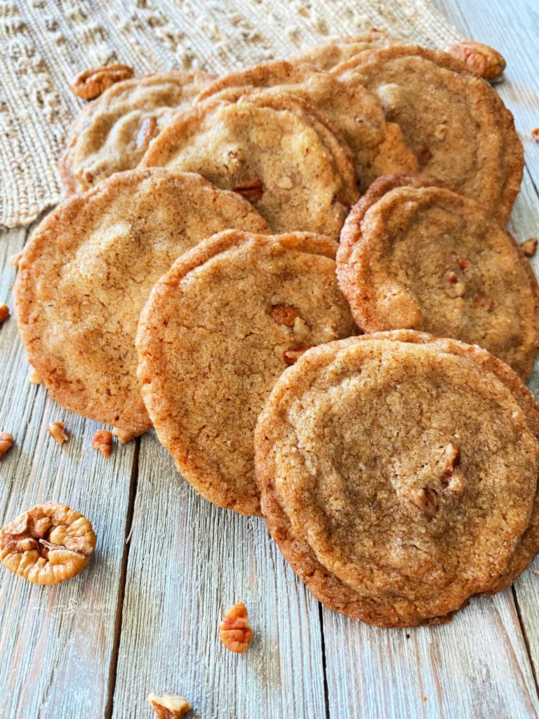 Pecan Butter Cookies lined up on a wood table