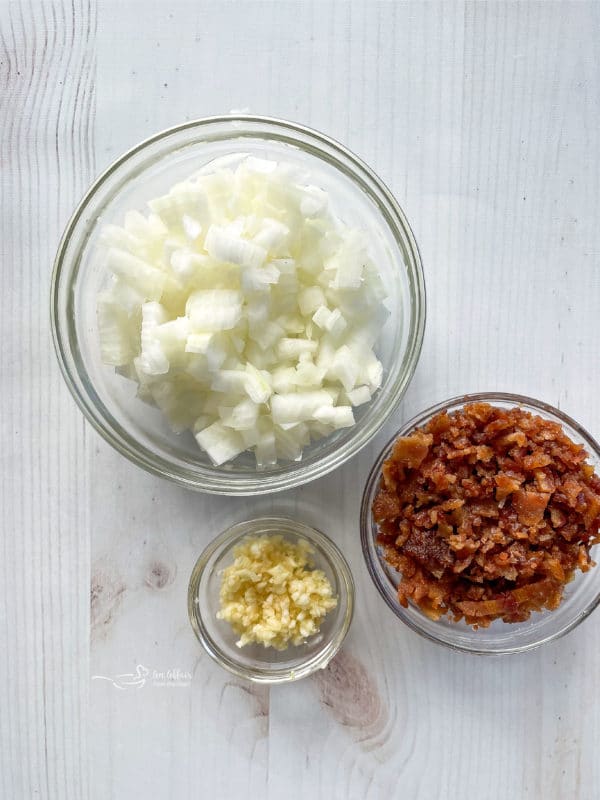 three bowls filled with onions, bacon, and garlic 