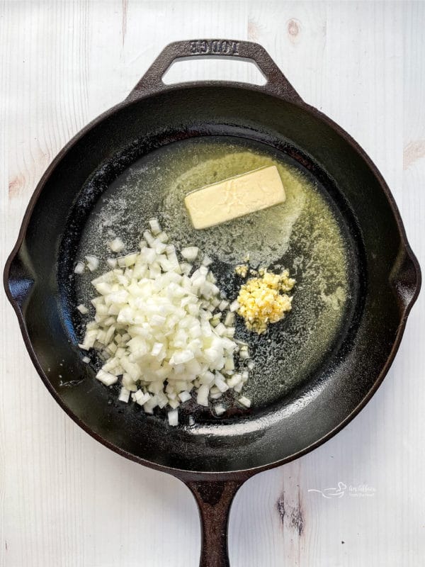 melting butter in skillet with onion and garlic
