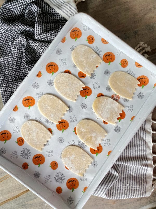 arranging pop tart ghost cutouts on baking sheet