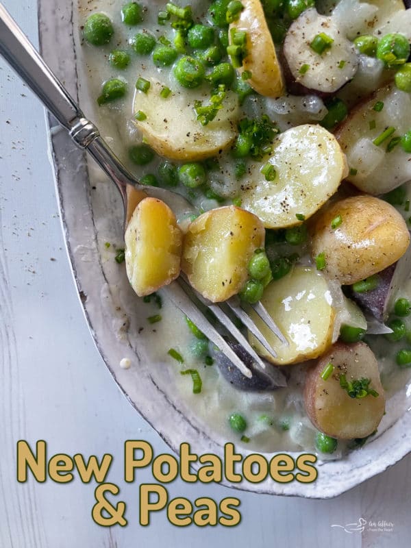 top view of cooked potatoes and peas in baking dish with rich white sauce