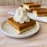 Pumpkin Pie Bars with Shortbread Crust close up with whipped cream