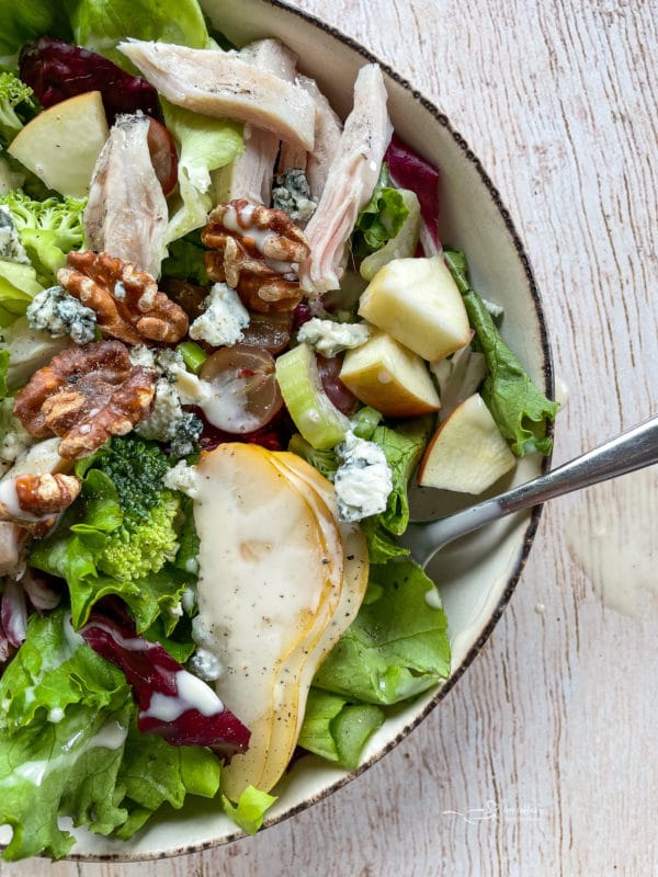 top view of Waldorf salad recipe in bowl with walnuts and pears