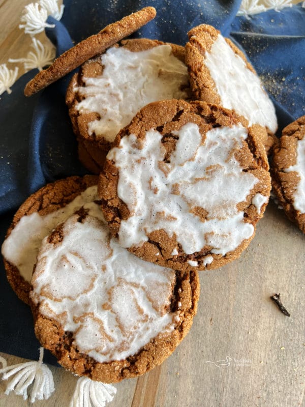 top view of iced molasses cookies with blue linen 