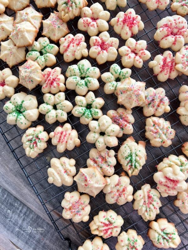 top view of spritz cookies on wire rack with sprinkles