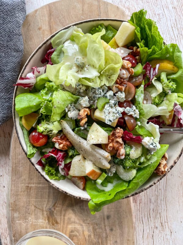 top view of bowl with fruit and leafy greens and chicken