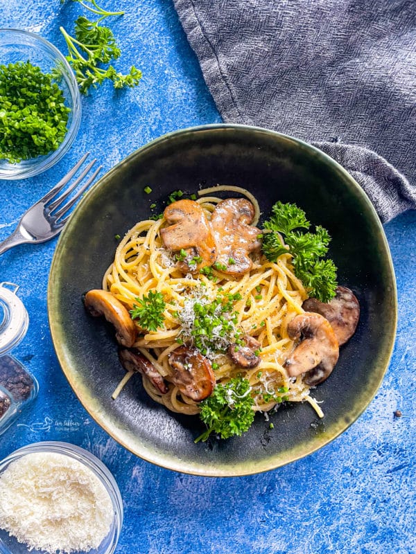 one bowl of cacio e pepe with mushrooms and parsley