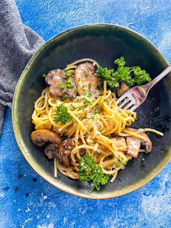 one bowl of cacio e pepe with mushrooms and fork 