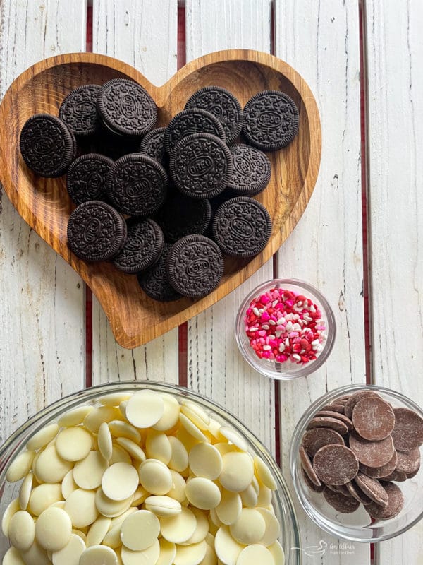 Oreos in heart dish with white candy melts and milk chocolate with sprinkles