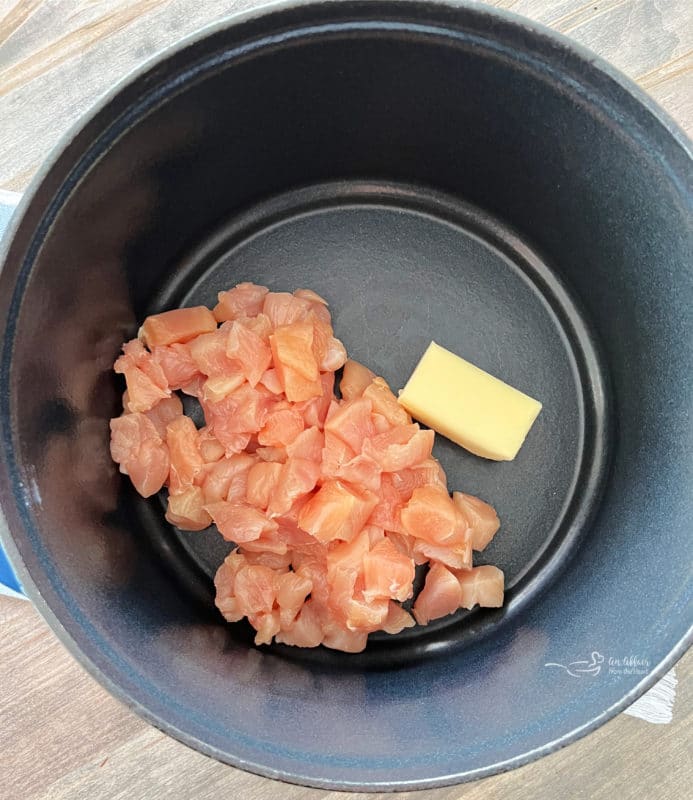 cooking chicken in pan with butter