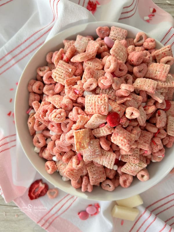 top view of rice chex in bowl with other pink puppy chow ingredients 