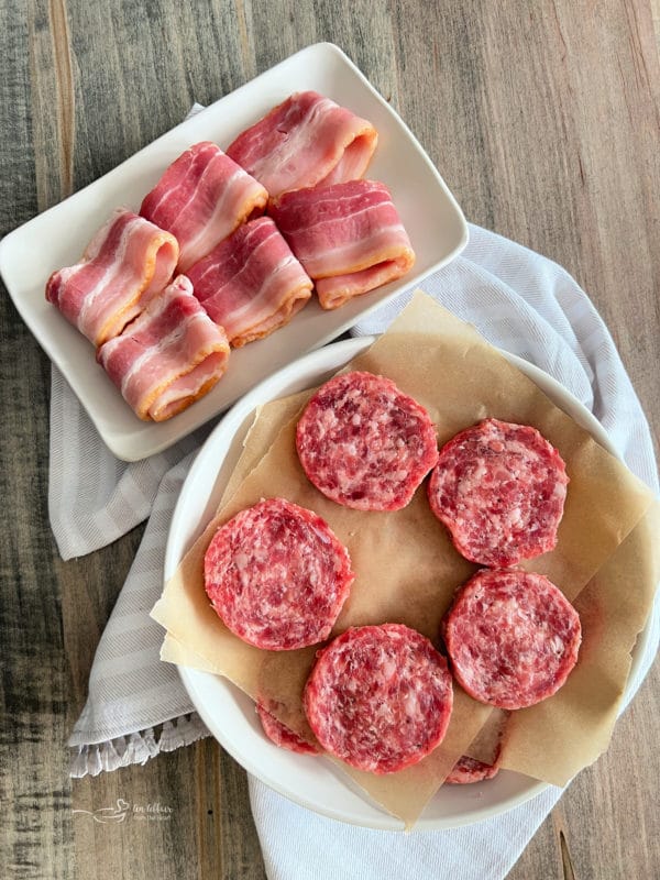 bacon and sausage patties on white plates