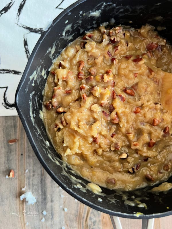 making the coconut pecan frosting for German chocolate cake in saucepan