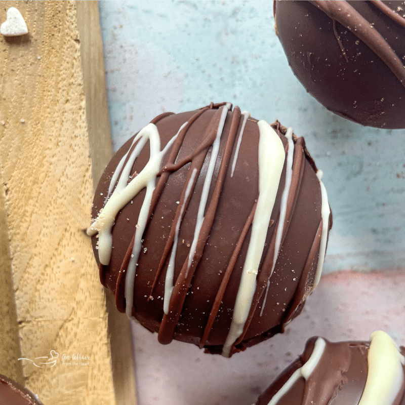 hot cocoa bomb drizzled with white chocolate