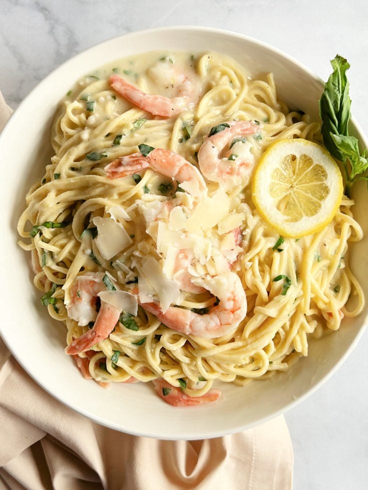 Shrimp Pasta in a Bowl with Lemon Slices and Basil