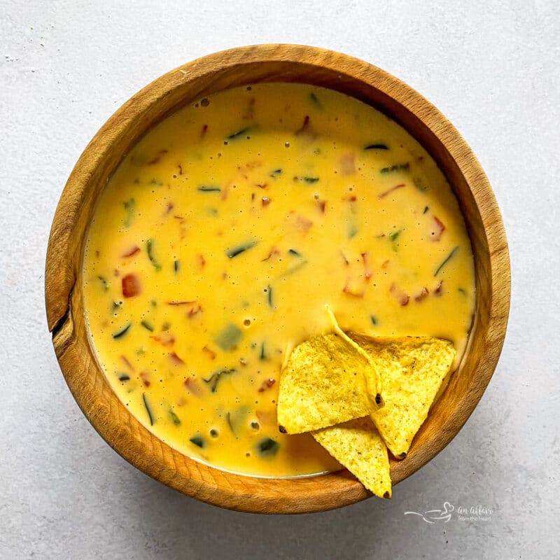 Chips Dipped in Cheese Sauce