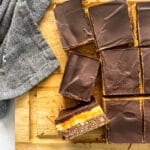 Nanaimo Bars sliced on a wooden platter