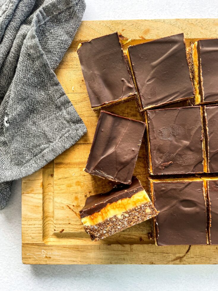 Nanaimo Bars sliced on a wooden platter
