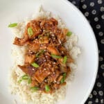 Slow Cooker Chicken Teriyaki on rice on a white plate