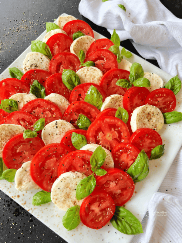 Caprese salad on a white square serving plate