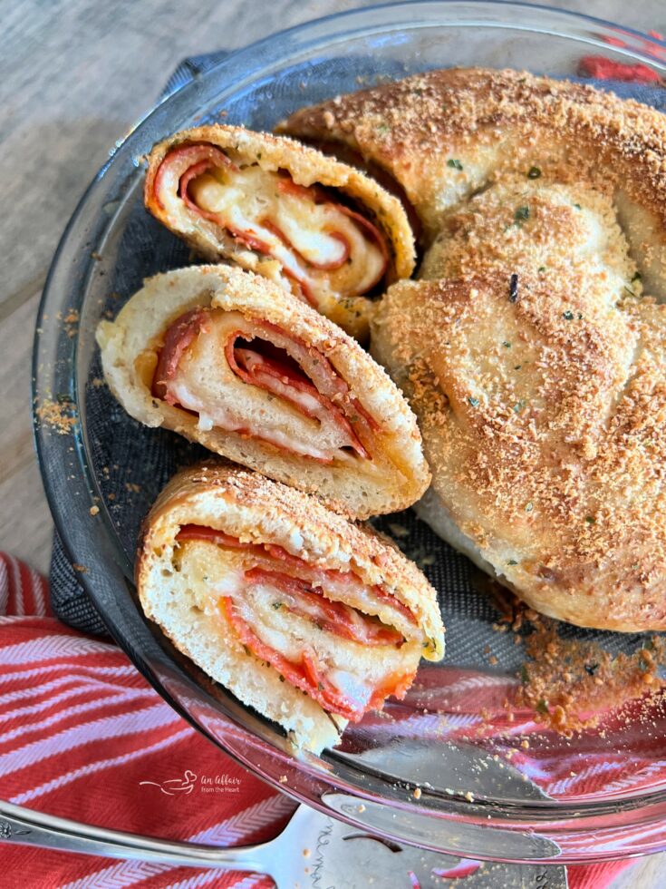 Sliced pepperoni pizza bread layered in a clear pie dish.
