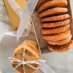 Orange ginger refrigerator cookies layered in a decorative box and tied with a string.