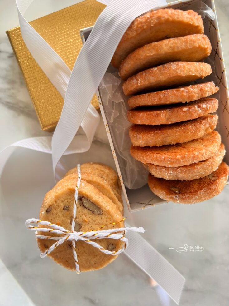 Orange ginger refrigerator cookies layered in a decorative box and tied with a string.