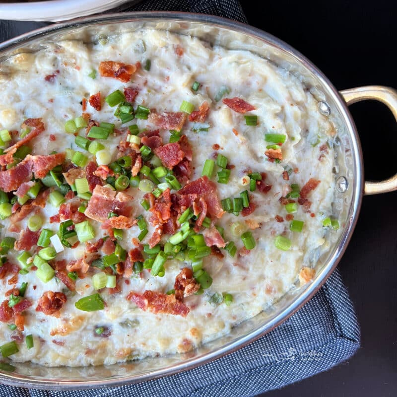 Sauerkraut, Bacon & Swiss Dip garnished with the green onions and bacon pieces