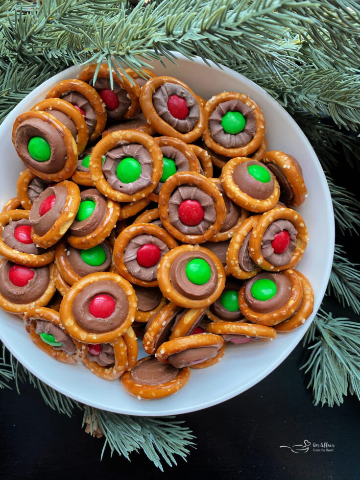Close up of Rolo pretzels stacked in a white serving bowl.