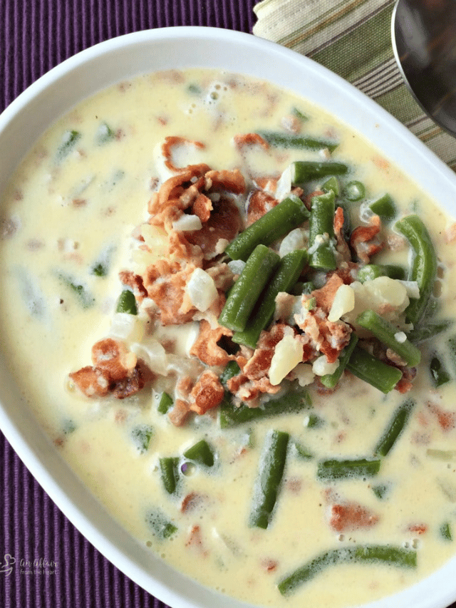 Close up of Potato Green Bean Bacon soup in a white serving bowl.