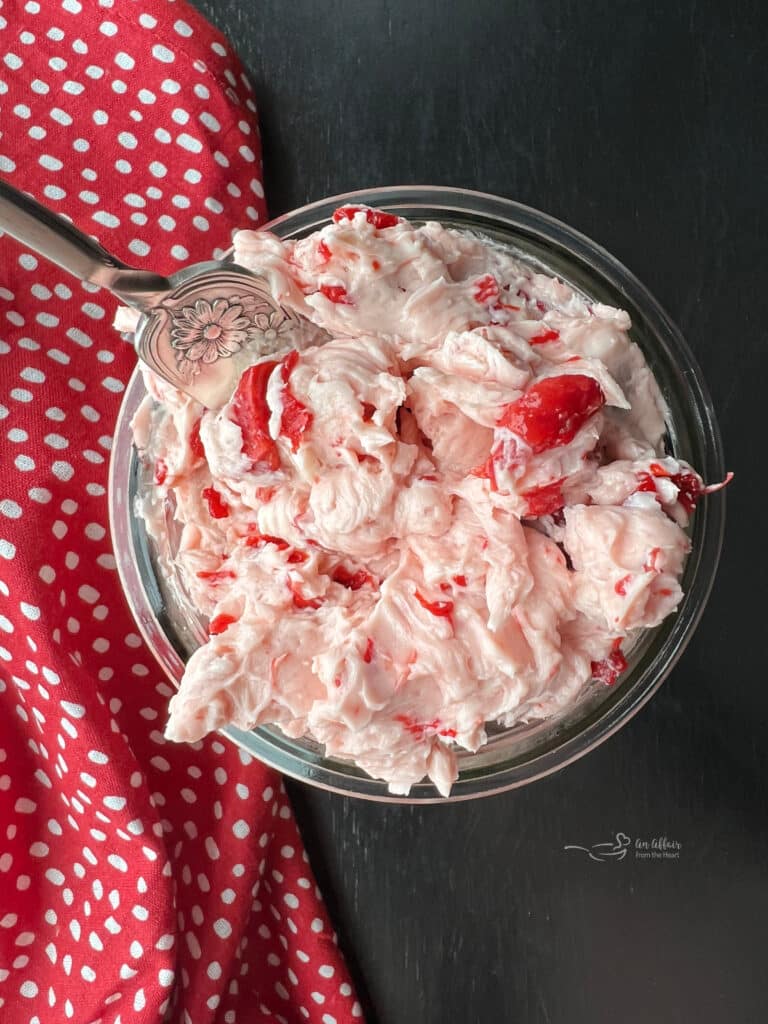 Overhead of cherry butter in a clear bowl.