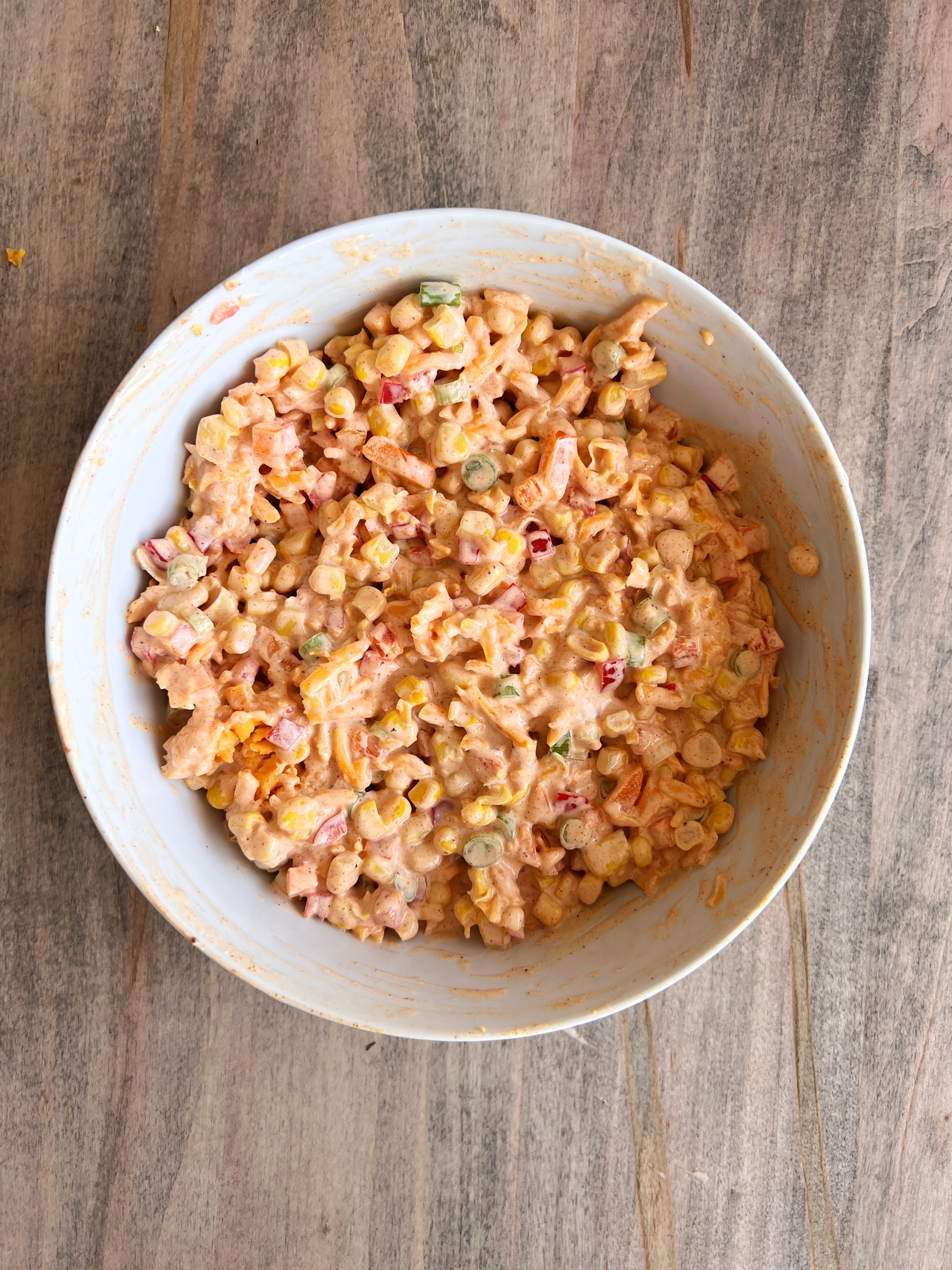 Fiesta Frito Corn Salad 7 Step 3: Covering the bowl of Frito Corn Salad with plastic wrap and placing it in the refrigerator
